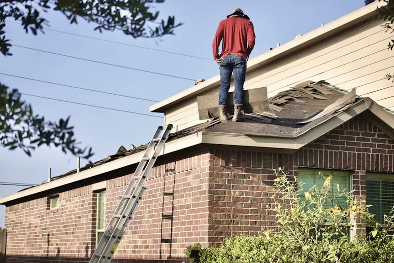Professional roofer working on a residential roof in Saint Charles
